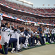 In this Nov. 26, 2017, file photo, Seattle Seahawks players sit and kneel during the playing of the national anthem before an NFL football game against the San Francisco 49ers, in Santa Clara, Calif.
